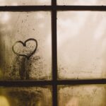 black framed glass window with heart draw