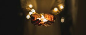 person holding string lights